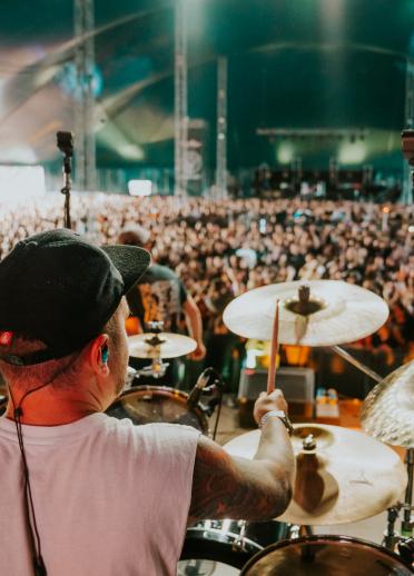 Over the shoulder shot of Ryan Richards on drums for Funeral for a Friend a large gig.