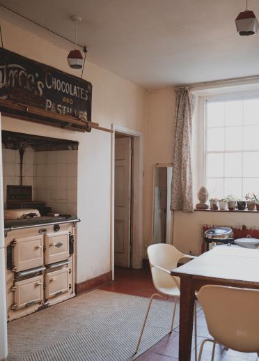 rustic white furniture that fills the farmhouse kitchen