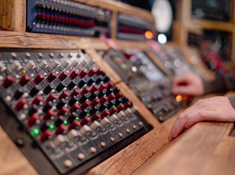 Close up shot of mixing desk in studio. 