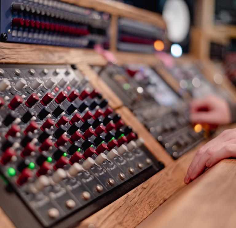 Close up shot of mixing desk in studio. 