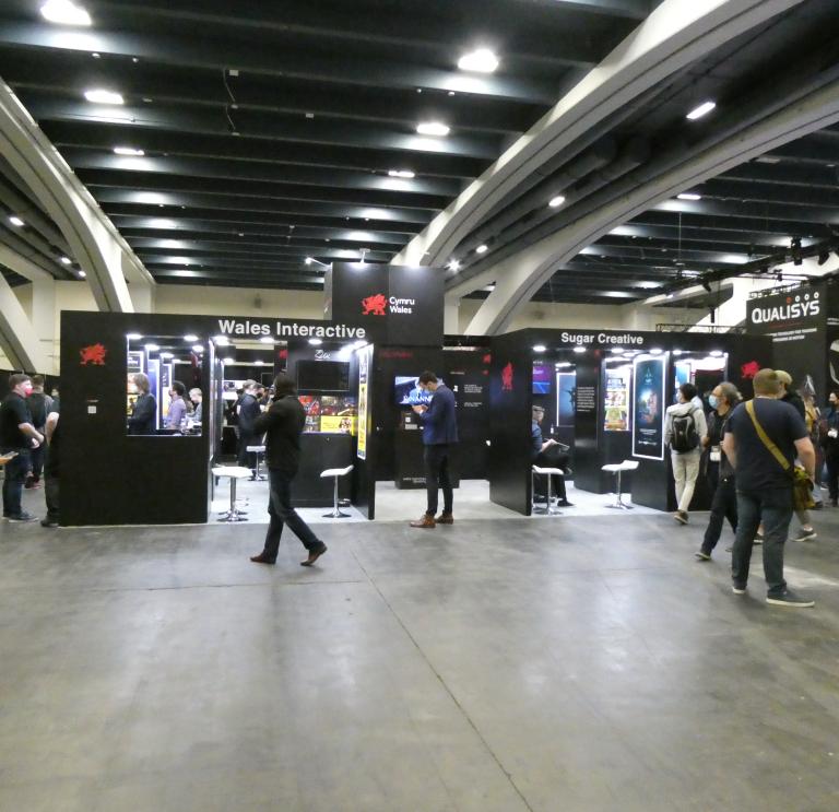 Wide shot of people browsing screens and stands at the Games Developer Conference