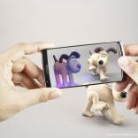 Close up of hands holding an iphone showcasing Gromit from Wallace Gromit