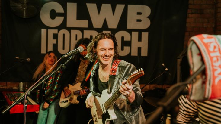 Close up shot of person playing the guitar at Clwb Ifor Bach.
